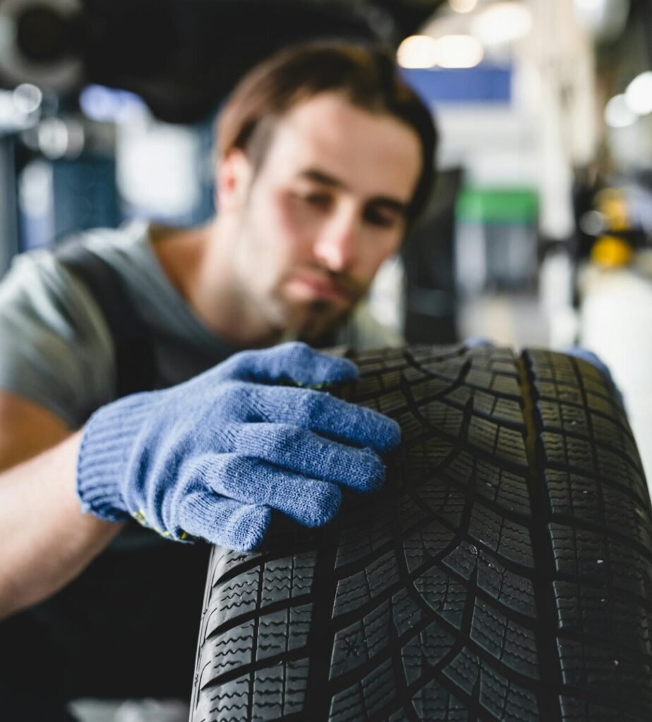 MOT. Vehicle inspection.Mechanic repairing fixing wheel tire of automobile at service station